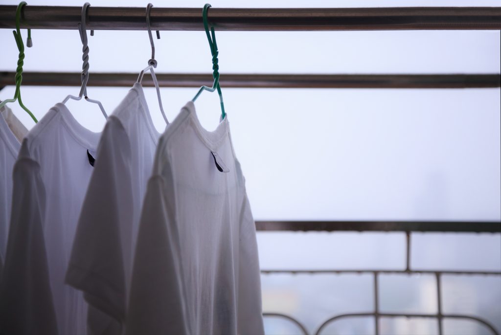 Musty t-Shirts hung to dry from smelling musty in the rainy season