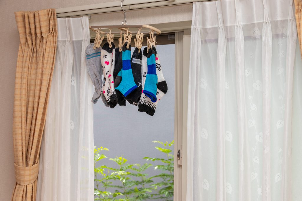 Socks hung to dry where air can pass, to keep clothes from smelling musty in the rainy season
